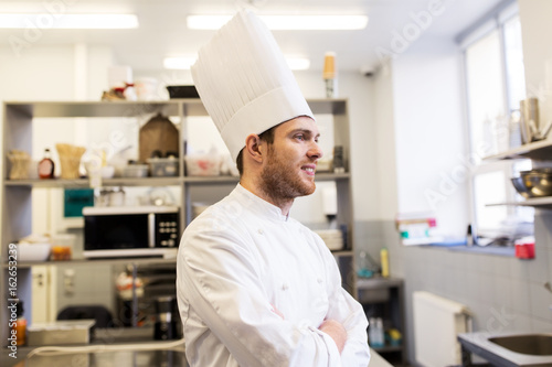 happy male chef cook at restaurant kitchen