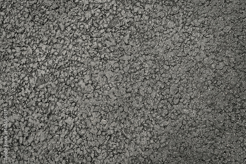 Dark grey asphalt background texture close up
