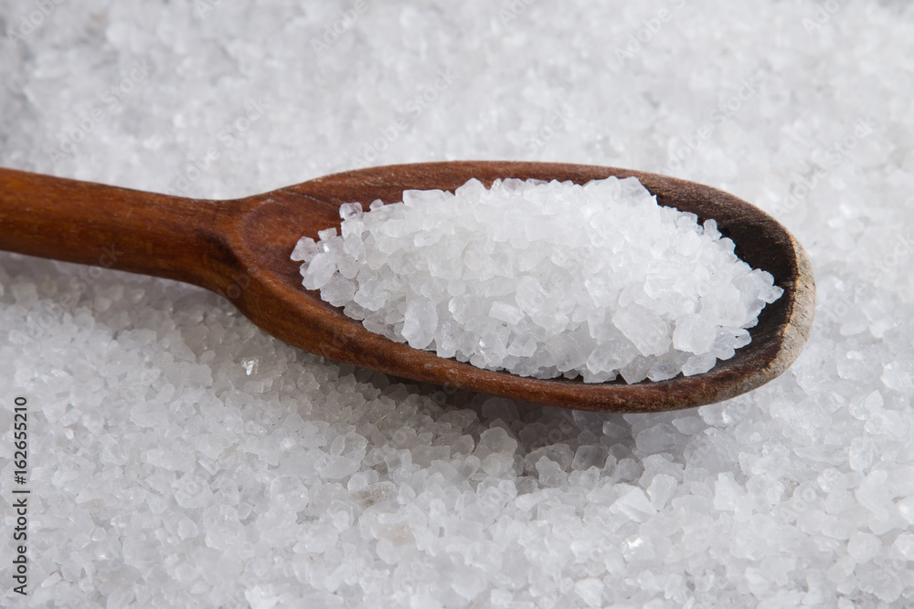 Wooden spoon in sea salt. Sea salt close up Wooden spoon in sea salt. Sea salt close up