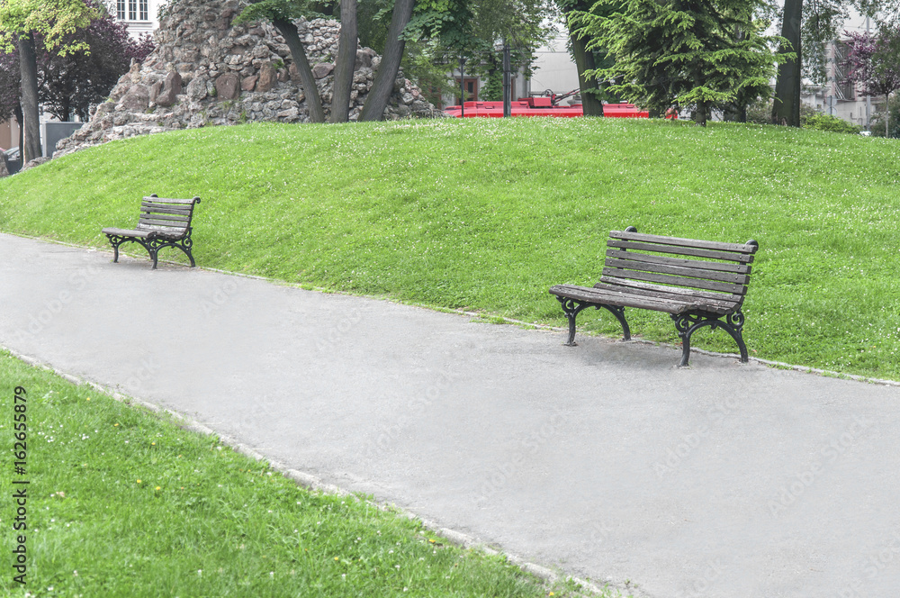 Two old rusty bench in the park in the city center Two old rusty bench in the park in the city center