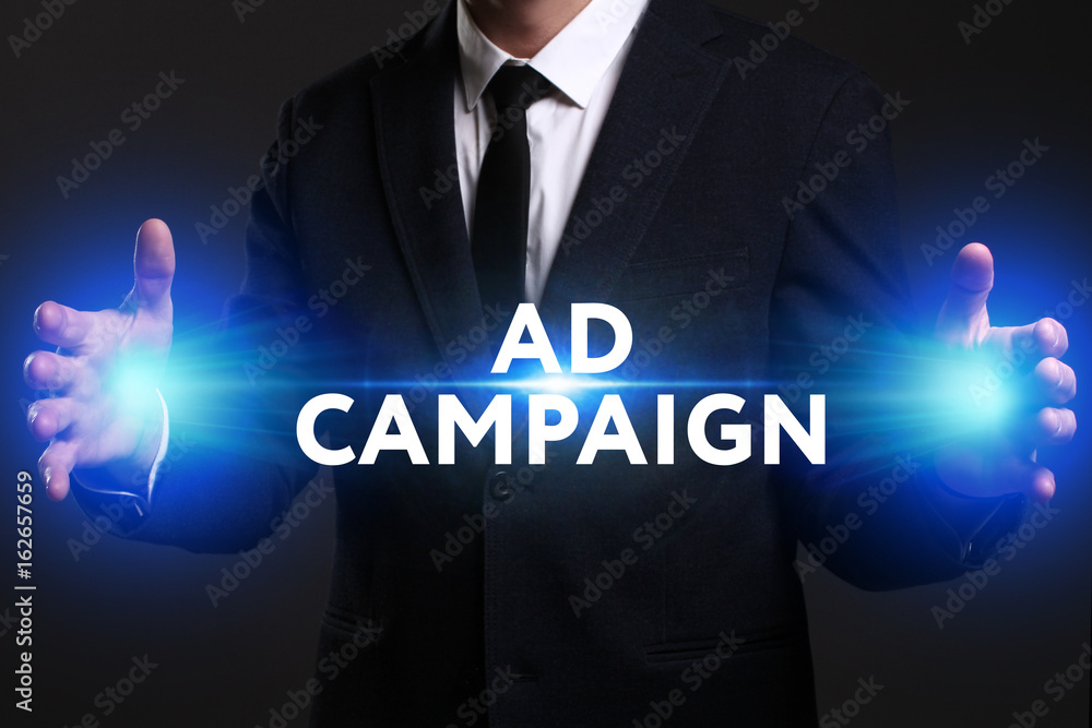 Business, Technology, Internet and network concept. Young businessman working on a virtual screen of the future and sees the inscription: Ad campaign Business, Technology, Internet and network concept. Young businessman working on a virtual screen of the future and sees the inscription: Ad campaign