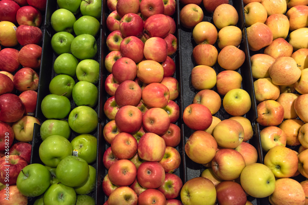 Colorful pile of fresh red, green, yellow apples for sale at local