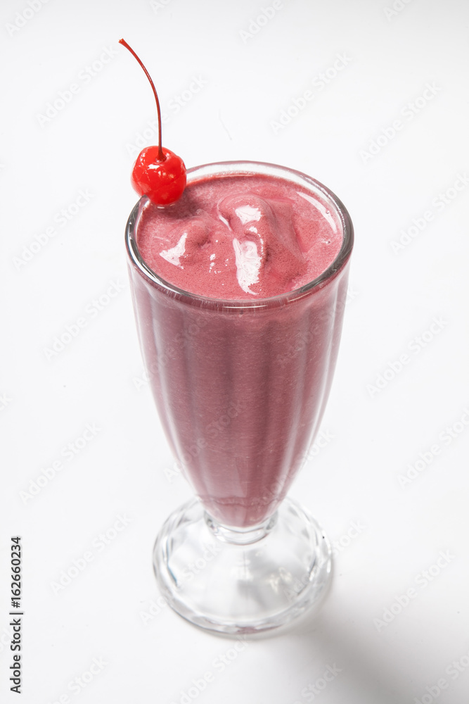Strawberry Shake decorated with cherry on a white background Strawberry Shake decorated with cherry on a white background
