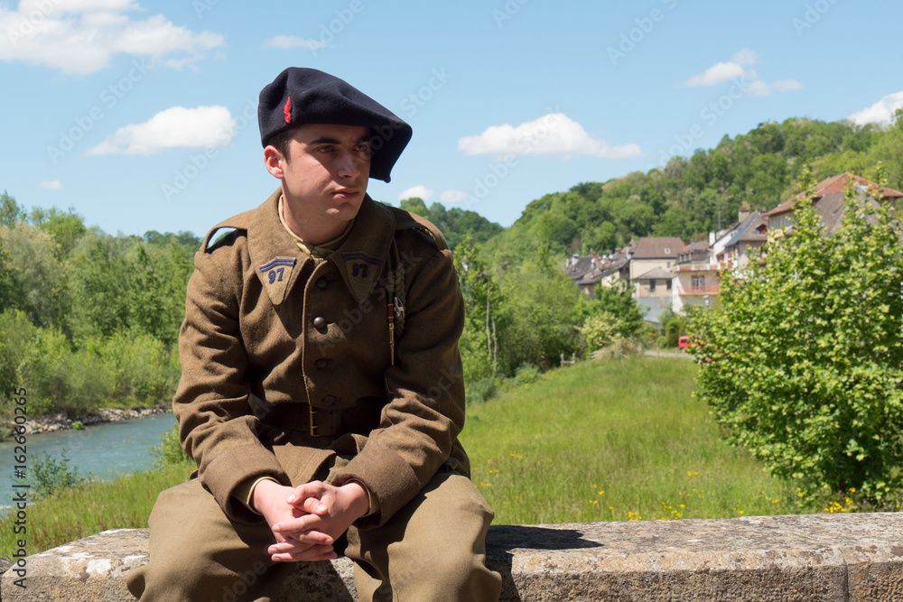 french soldier in 1940's uniform, sitting outdoor