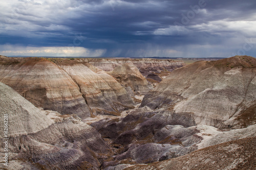 A  landscape of  a valley and colorful rock hills in the Petrified Forest National Park- Blue Mesa Trail