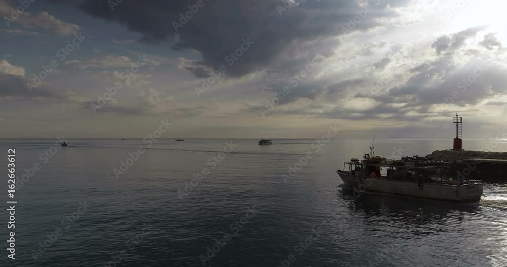 Red metal lighthouse at entrance to small harbor of Cattolica in the Adriatic coast at sunrise, Italy. Red metal lighthouse at entrance to small harbor of Cattolica in the Adriatic coast at sunrise, Italy.