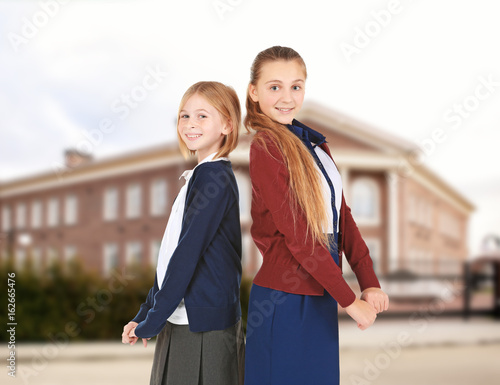 Two cute girls in school un...