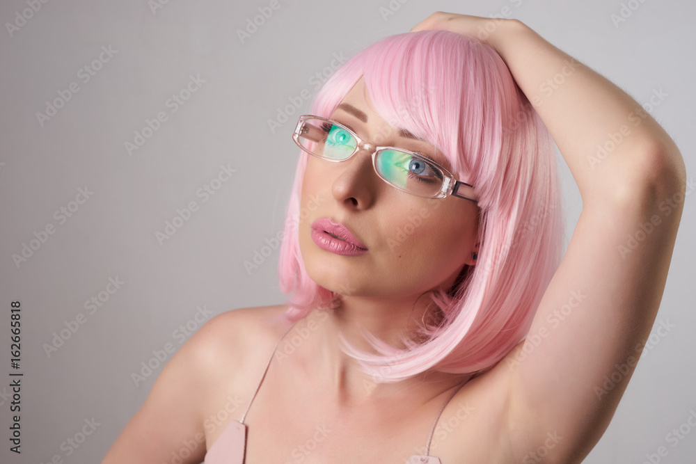 Close-up portrait of beauty Fashion Model pink hair color. Fringe Hairstyle. Hairdressing. Beautiful Glamour Girl with Short blonde hair In stylish optical glasses . Dyed hair, perfect make-up. Close-up portrait of beauty Fashion Model pink hair color. Fringe Hairstyle. Hairdressing. Beautiful Glamour Girl with Short blonde hair In stylish optical glasses . Dyed hair, perfect make-up.