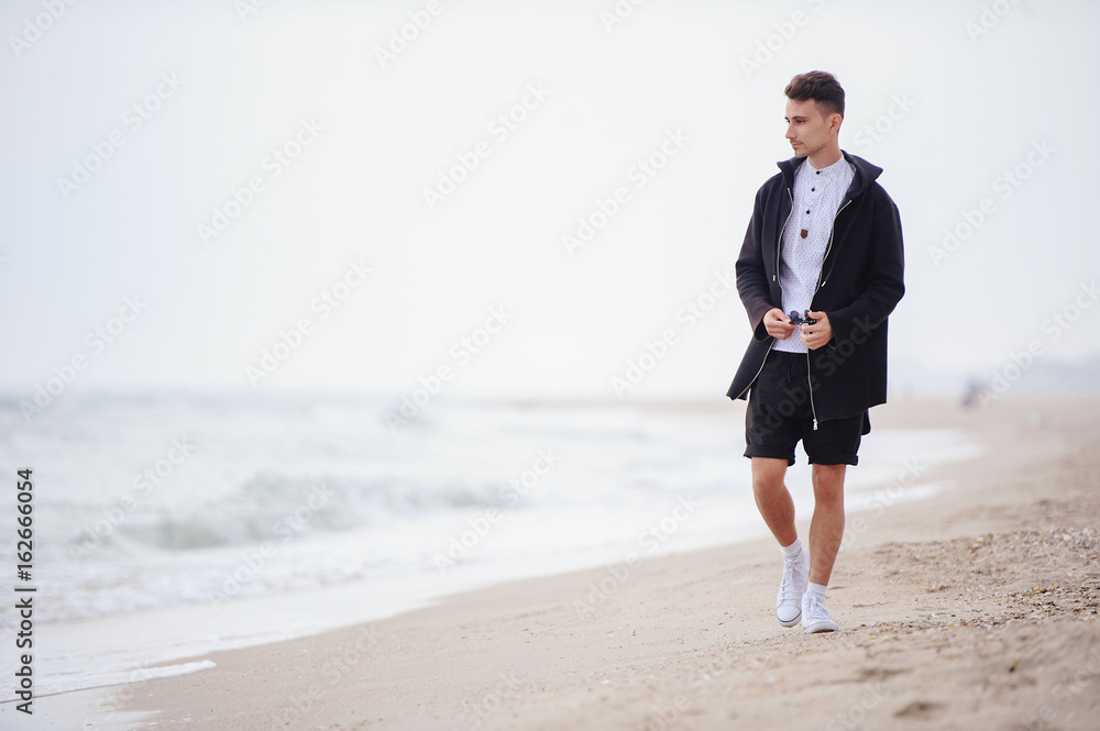 Young fashionable man on the beach, cool Young fashionable man on the beach, cool