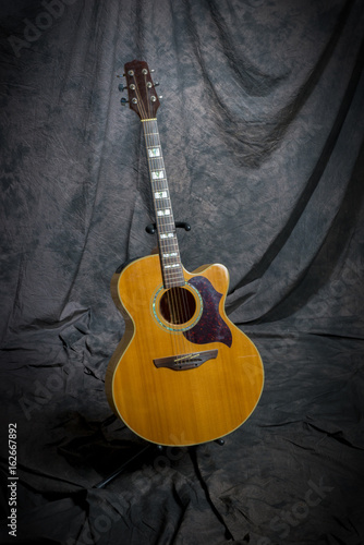 acustic guitar on stand in studio