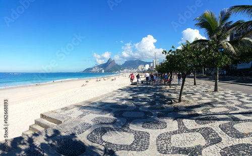 Ipanema, Rio de Janeiro, Brazil - June 25, 2017 - View of Ipanema beach with its famous geometric boardwalk in summer day with blue sky