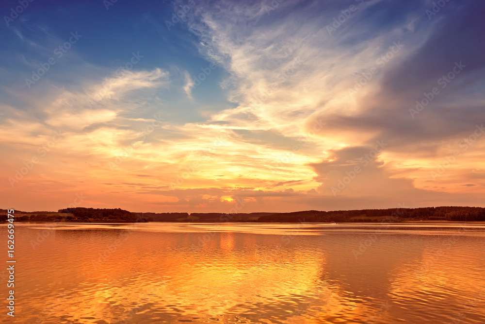 sunset over lake with colorful sky background.