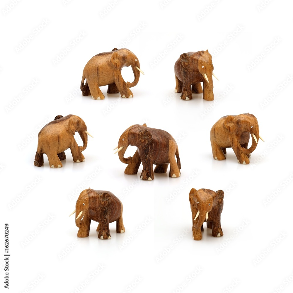 Obraz premium Wooden souvenir elephant made of wood and ivory on a white background