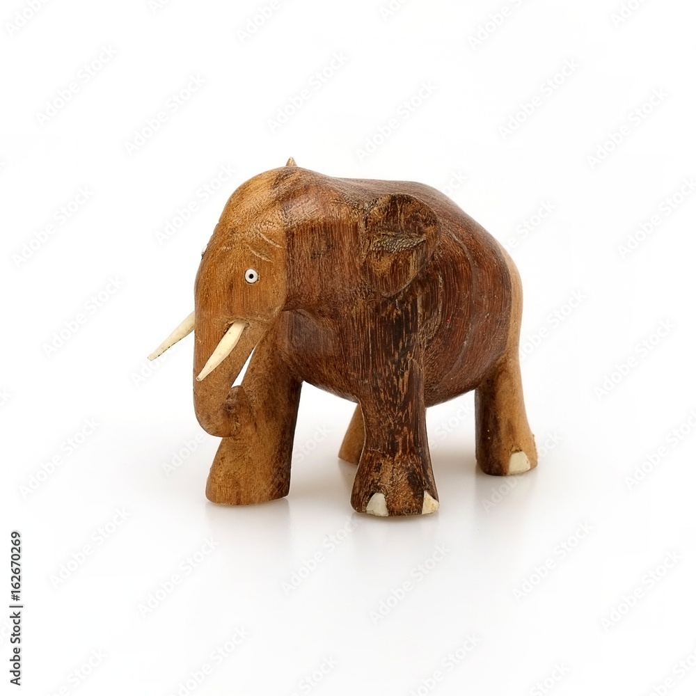 Wooden souvenir elephant made of wood and ivory on a white background