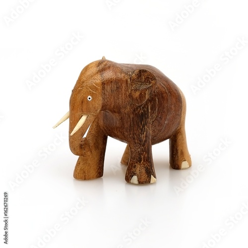Wooden souvenir elephant made of wood and ivory on a white background