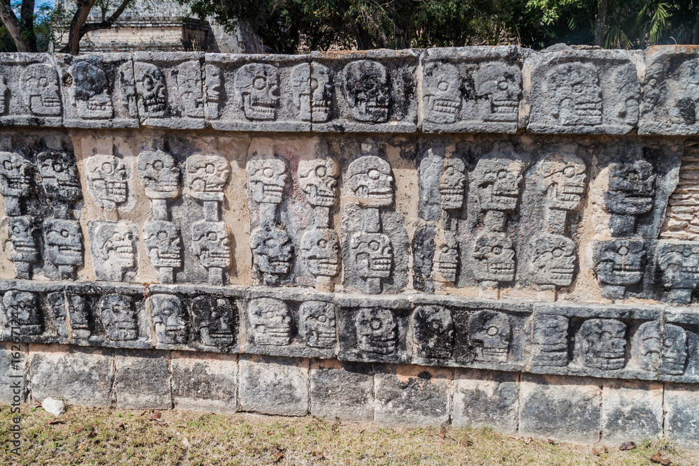 Carved skulls at the Platform of Sculls at the archeological site Chichen Itza, Mexico