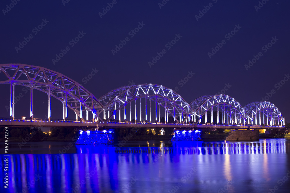 Fototapeta premium Railroad bridge over river Daugava in Riga at night