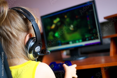 Little Girl playing a computer games
