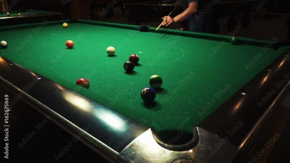 Video Stock Playing billiards, blowing a cue on the ball, the ball hit