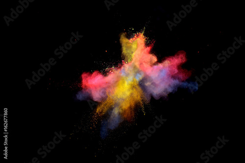 Bizarre forms of multi color powder paint and flour combined exploding in front of a black background to give off fantastic colors and forms.
