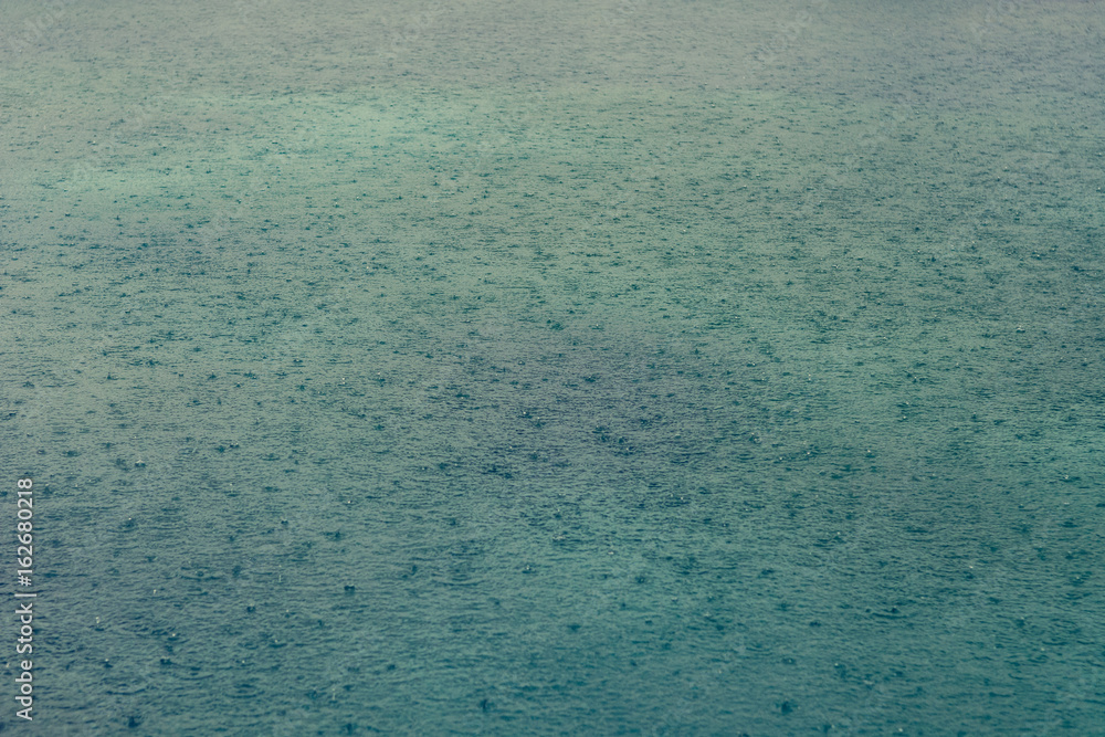 Obraz premium Rain drops on lake surface.