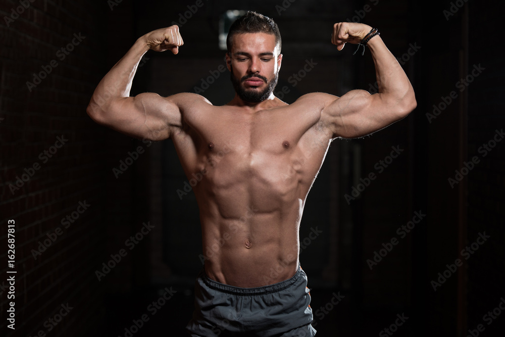 Fitness Model Posing Double Biceps After Exercises