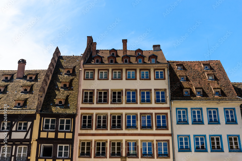 Fototapeta premium Detail of a building in the city centre of Strasbourg against blue sky