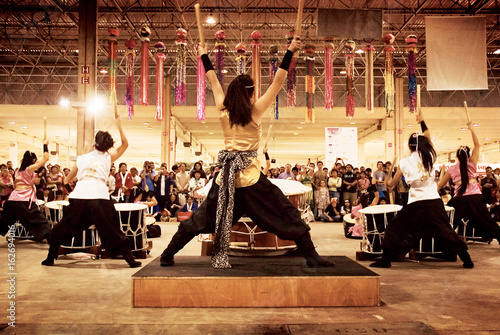women playing taiko to the public
