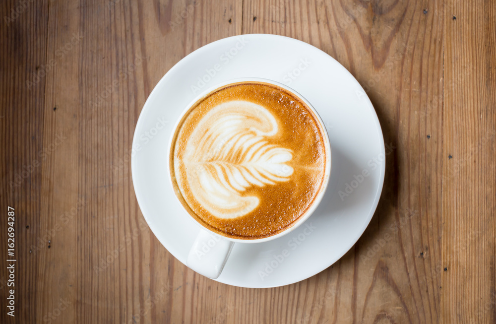 Coffee latte art on wood table