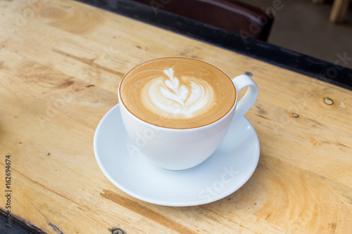Coffee latte art on wood table
