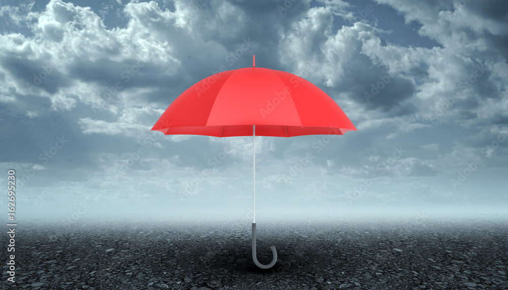 An open red umbrella with a black handle vertically placed above dark grey pavement on stormy sky background.