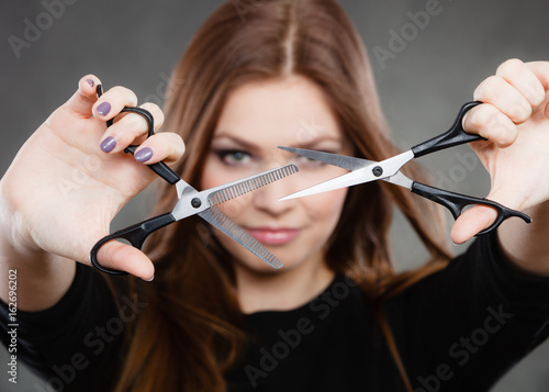 Professional hairdresser with scissors ready to cut.