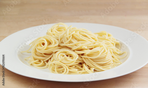 Spaghetti pasta. Wooden background. Close up view. 