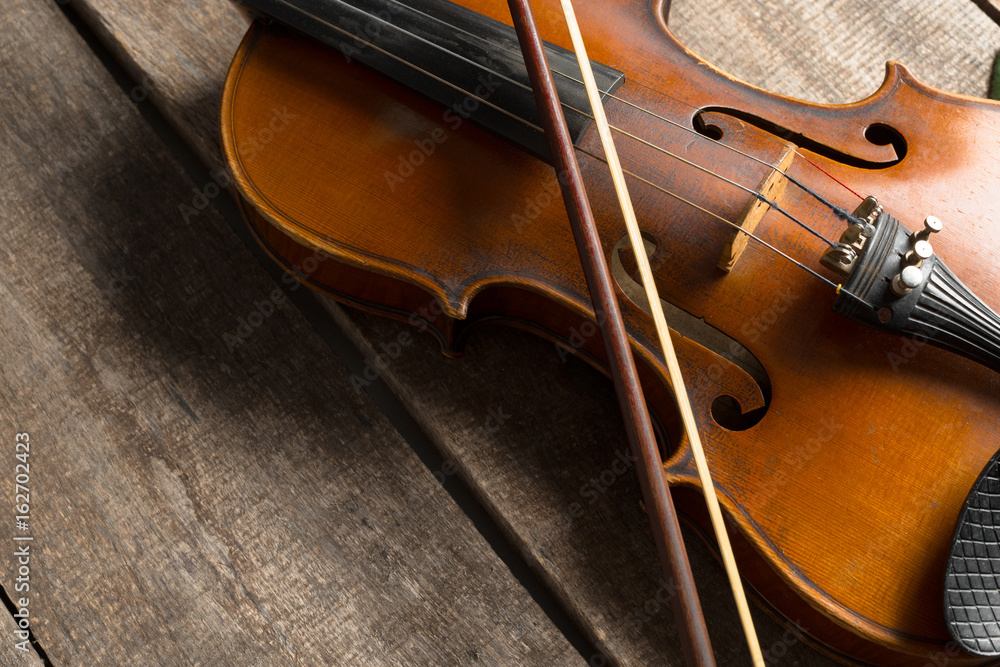 Violin on a wooden textured table Violin on a wooden textured table