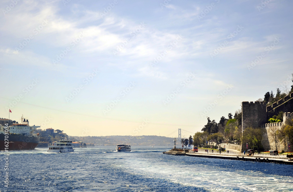 Ferries float on Bosphorus waterway with Galata on the background