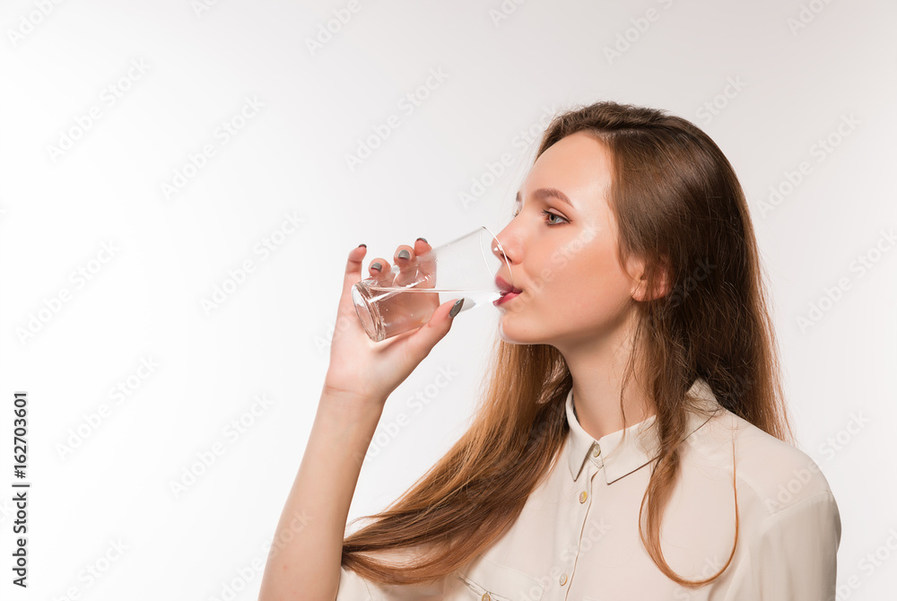 Young girl drinks clean water from a glass Young girl drinks clean water from a glass