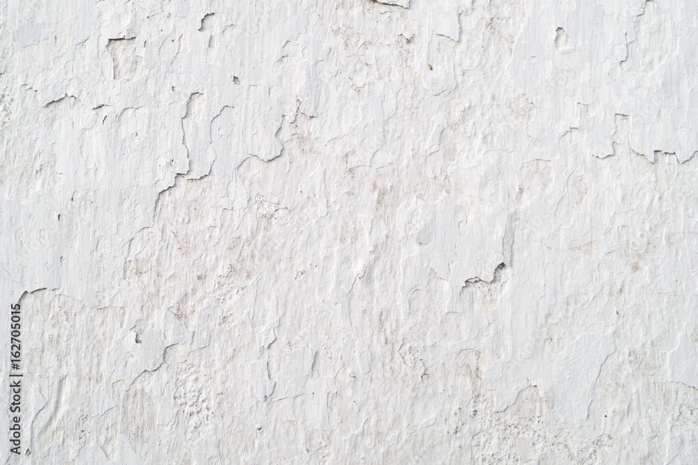 Old cracked wall covered white plaster, background, texture