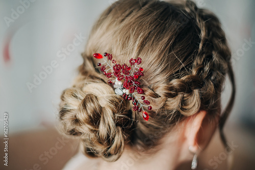 Hair with braided braids and accessories with red stones photo