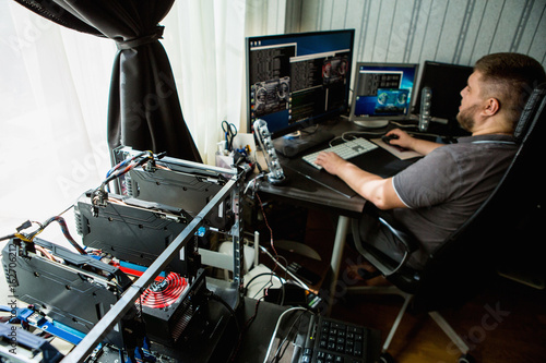 Фотография Programmer configures the computer for bitcoin mining