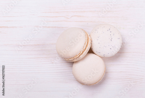 Fresh, cream-colored macaroons on a white background