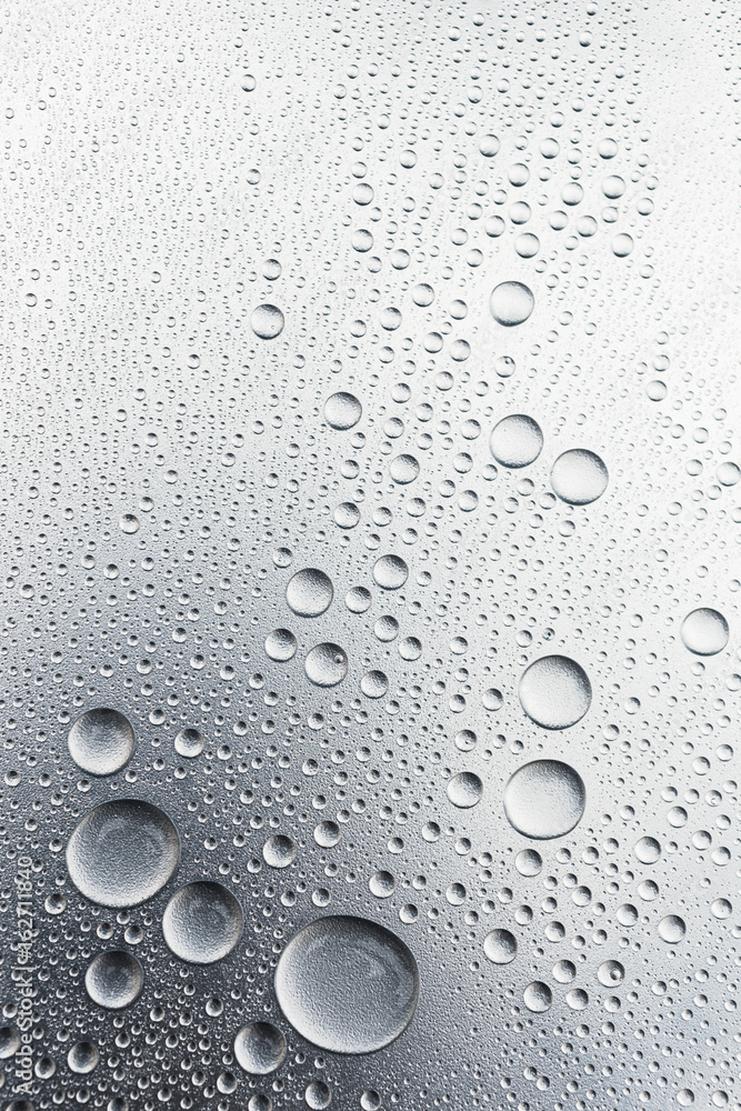 Water drops on silvery surface, background	