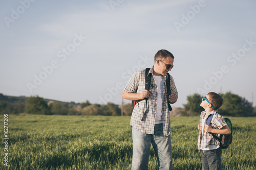 Father and son playing on the field at the day time.