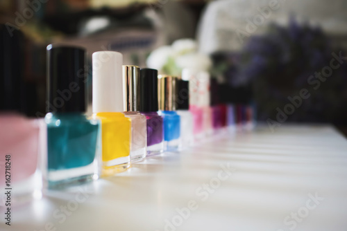 Set of different nail varnishes on shelves in cosmetic store