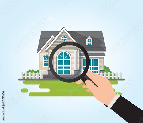Magnifying glass in human hand with house icon.