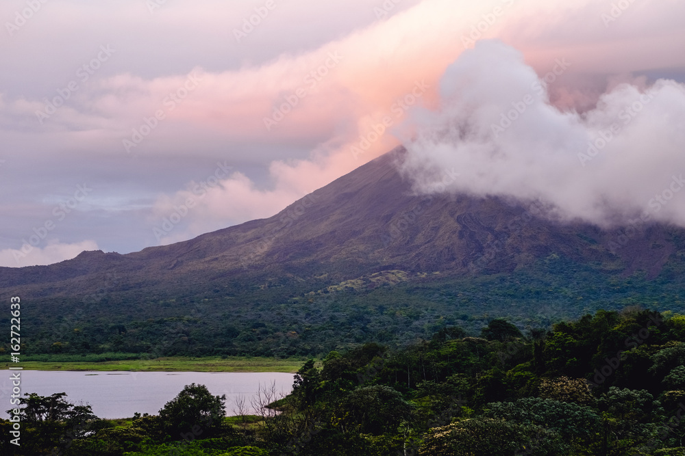 Volcano of Arenal covered in clouds at sunrise. Costa Rica
