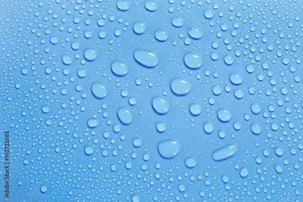 Water drops on smooth surface, blue background Water drops on smooth surface, blue background