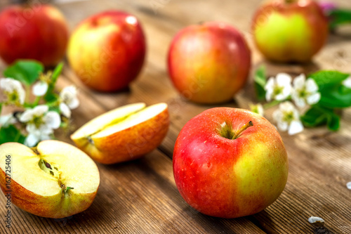 Raw organic apples on wooden background