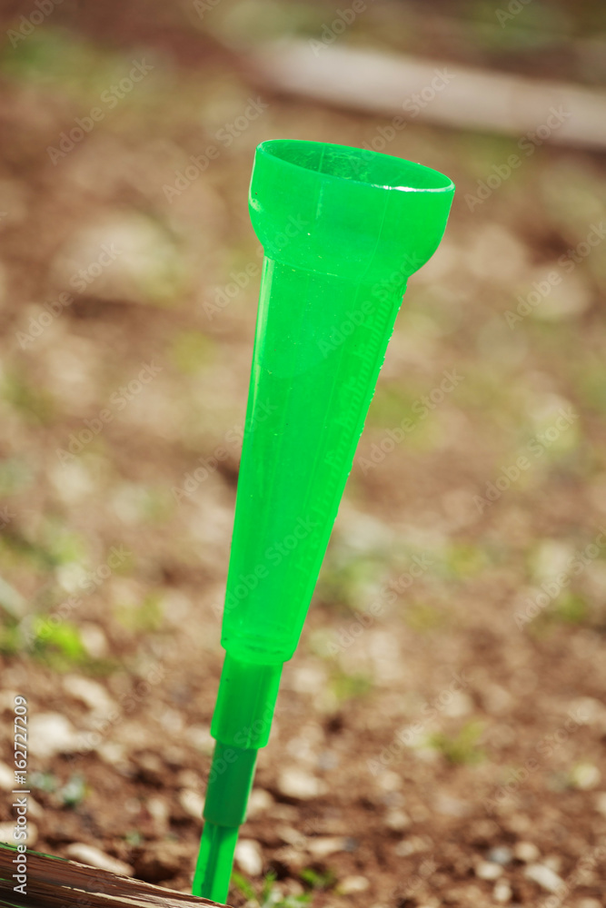 closeup on rain gauge in a garden to measure the quantity of rain closeup on rain gauge in a garden to measure the quantity of rain