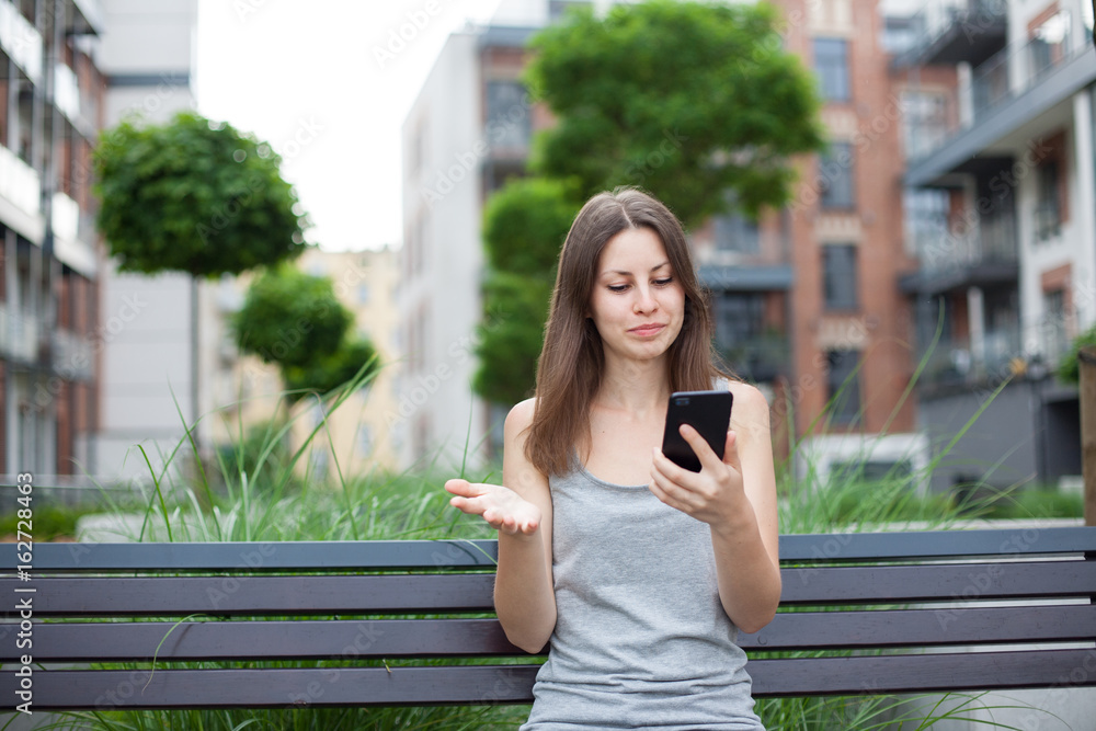 Young woman uses Internet from phone Young woman uses Internet from phone
