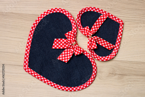 Two seamed hearts with beaded ribbons